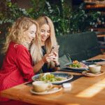 Two Businesswomen Working In A Cafe