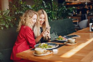 Two businesswomen working in a cafe