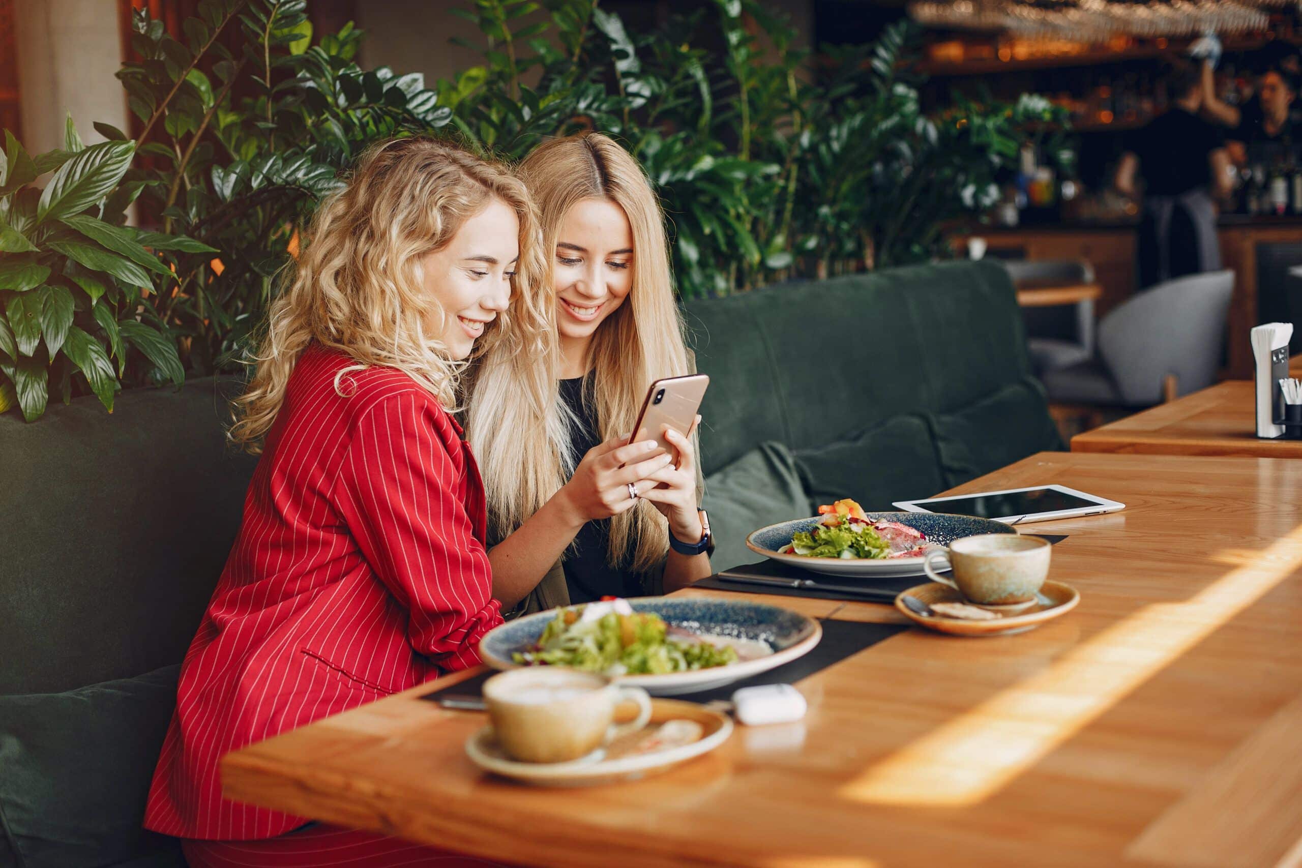 Two Businesswomen Working In A Cafe