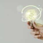 Green Energy With Hand Holding An Environmental Light Bulb Backg